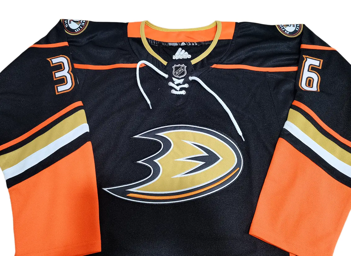 Close up of the Anaheim Ducks webbed-D crest embroidery and Reebok collar details